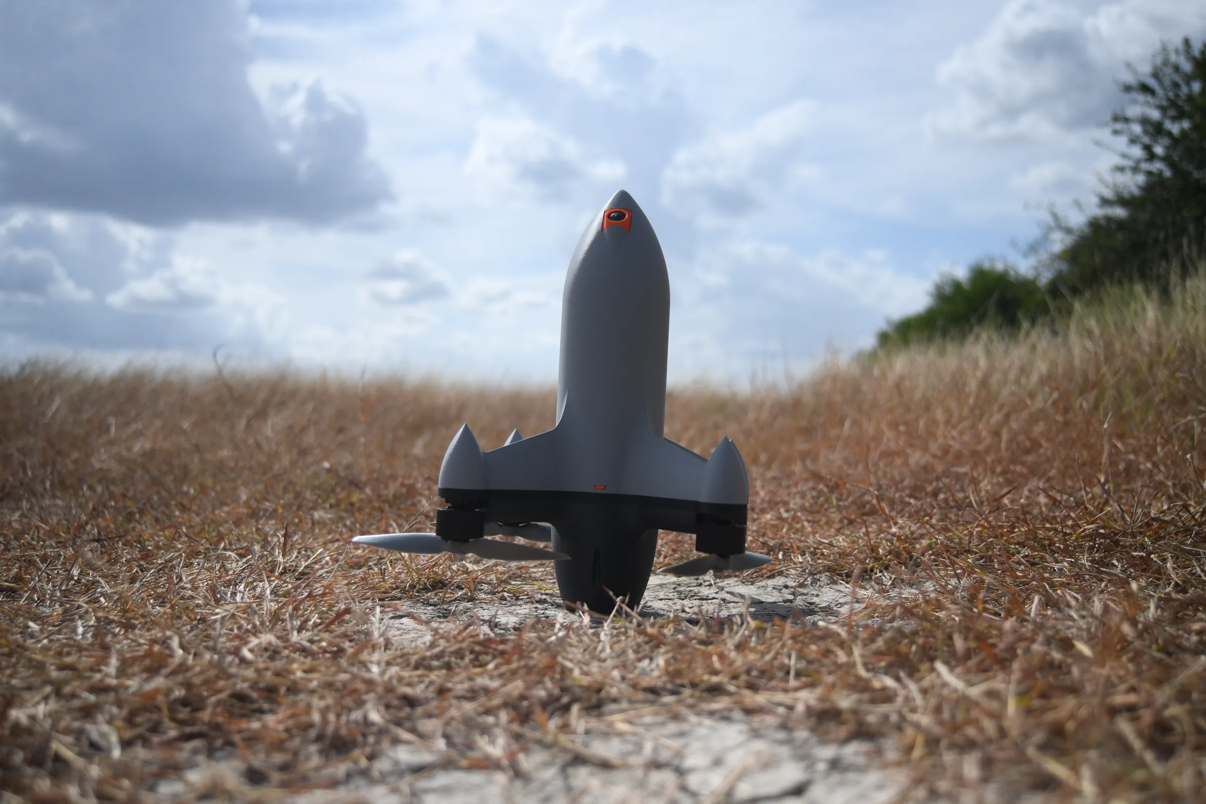 Unmanned Industries UI Interceptor, nose-up in a field with an orange nose camera
