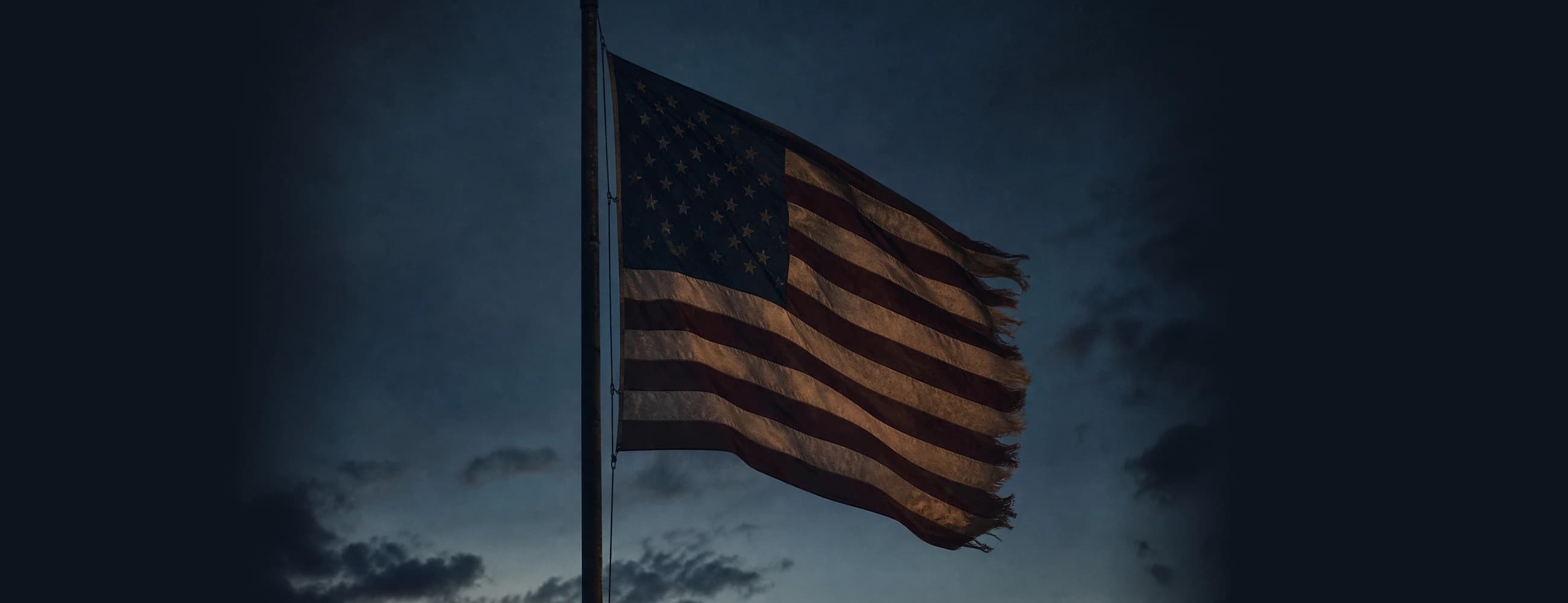 American flag flying at dusk over the Unmanned Industries production facility