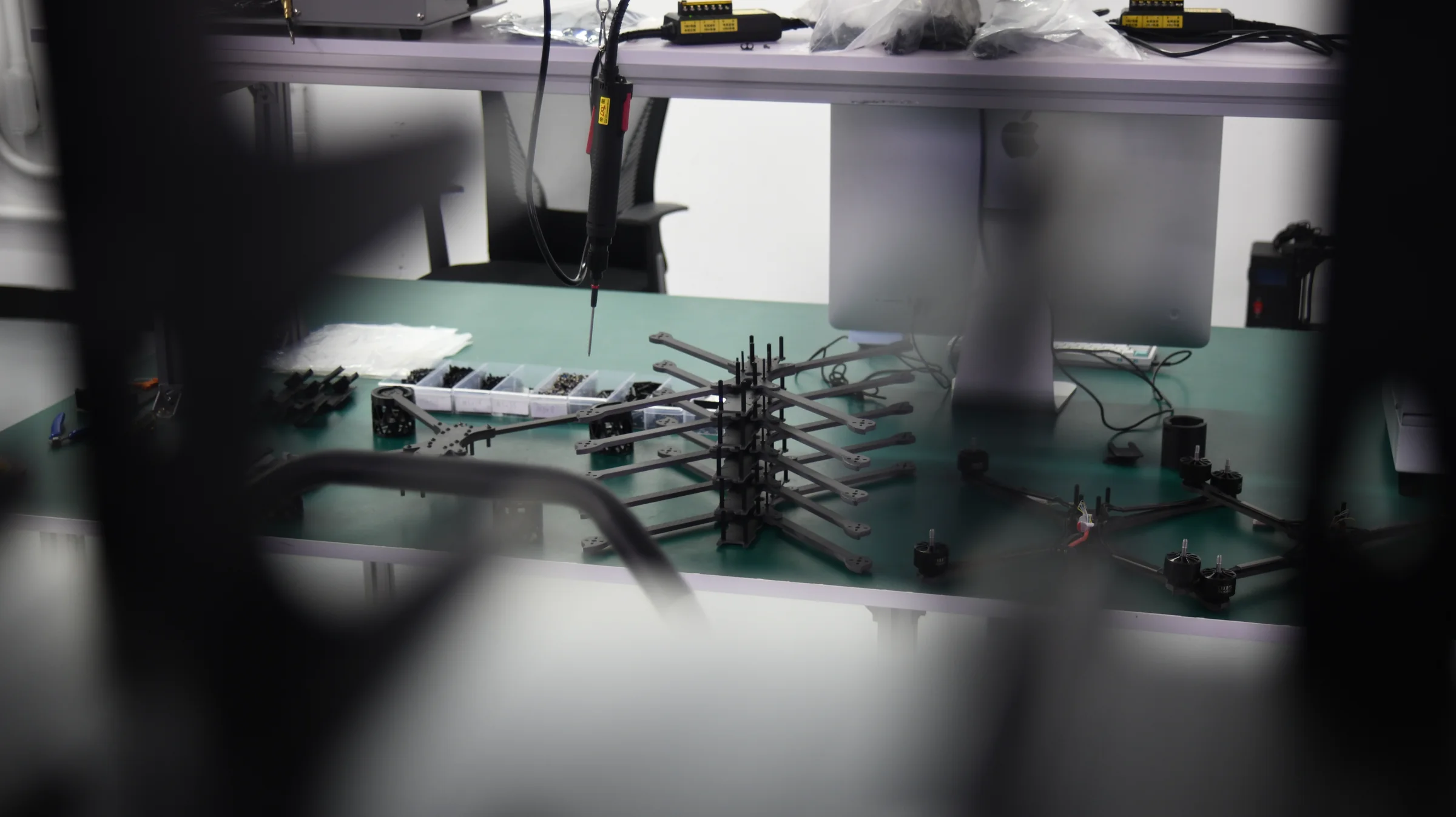 A technician assembling drone frame components at the Unmanned Industries production facility