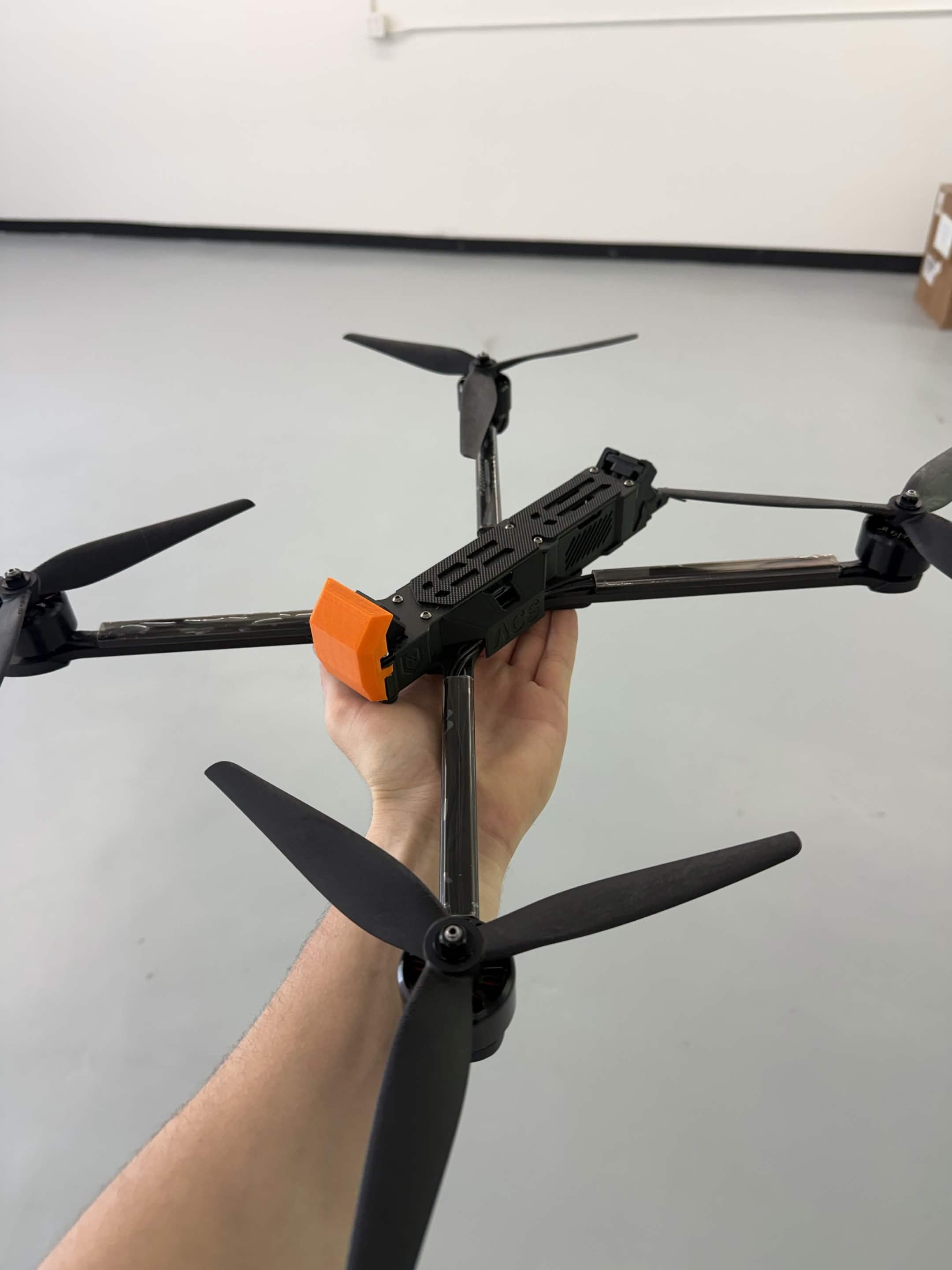 Unmanned Industries T100 FPV targeting and training unit held in hand